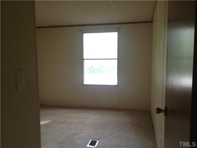 4491 Oxford Road Roxboro, NC 27574 - Photo 8 of 11 an empty room with a window