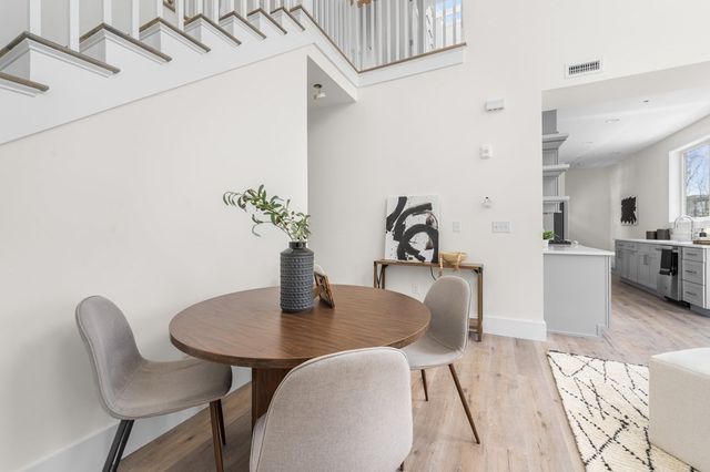 a dining room with furniture and wooden floor