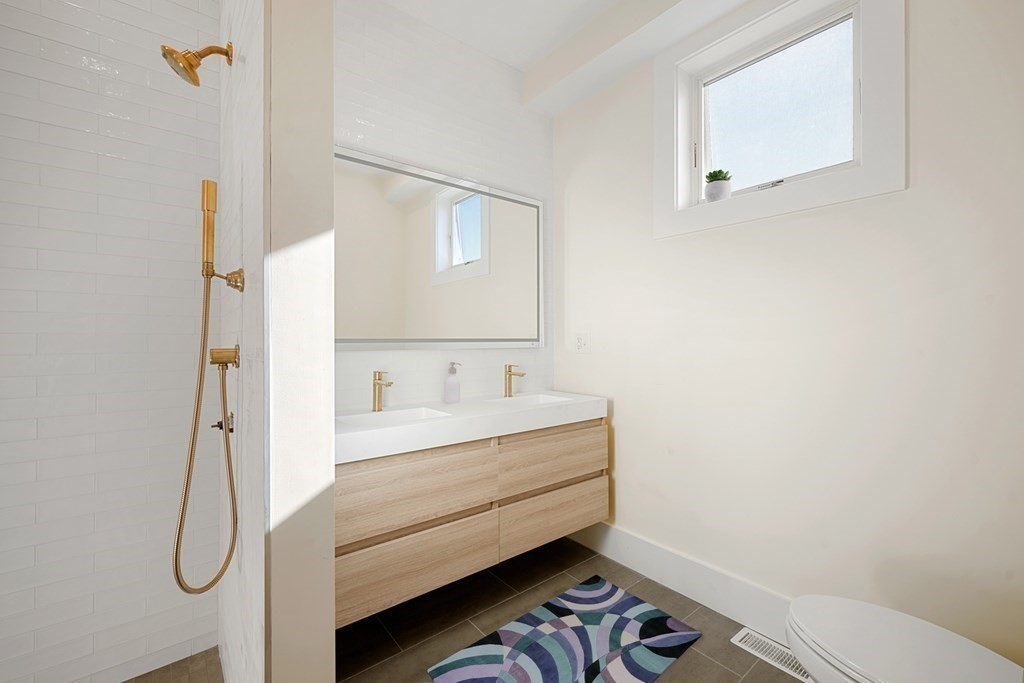 120 School Street, Unit 3 Boston, MA 02119 - Photo 16 of 30 a bathroom with a sink a toilet and mirror