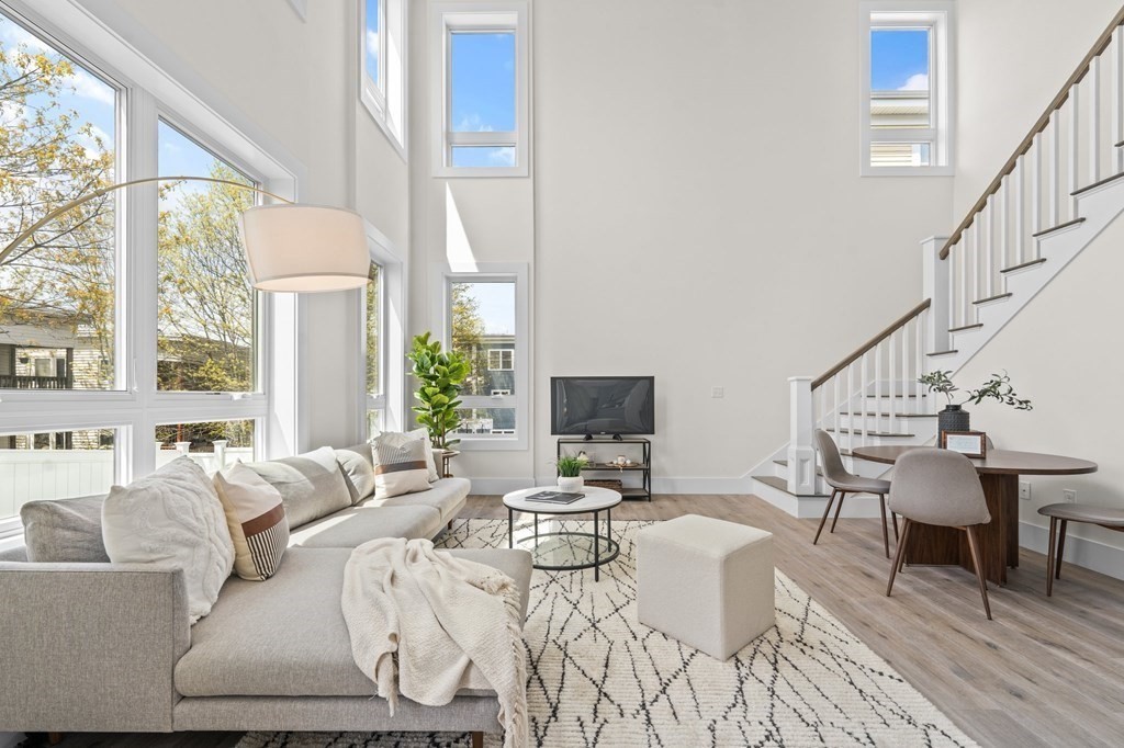 120 School Street, Unit 3 Boston, MA 02119 - Photo 2 of 30 a living room with furniture and a table with wooden floor