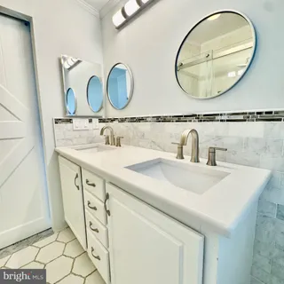 a bathroom with a sink mirror and vanity