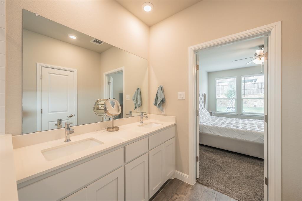 1212 Bosque Lane Weatherford, TX 76087 - Photo 30 of 38 a en suite bathroom with a double vanity sink and a mirror