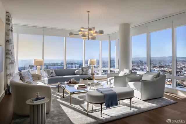 a very nice looking living room with a large window and furniture