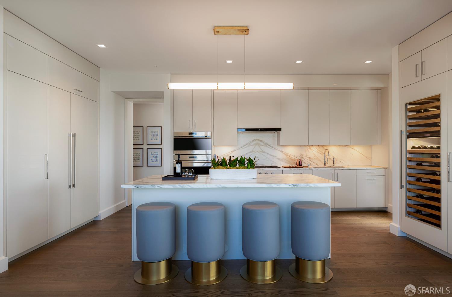 706 Mission Street, Unit 28A San Francisco, CA 94103 - Photo 3 of 30 a kitchen with stainless steel appliances granite countertop a stove a sink and a refrigerator