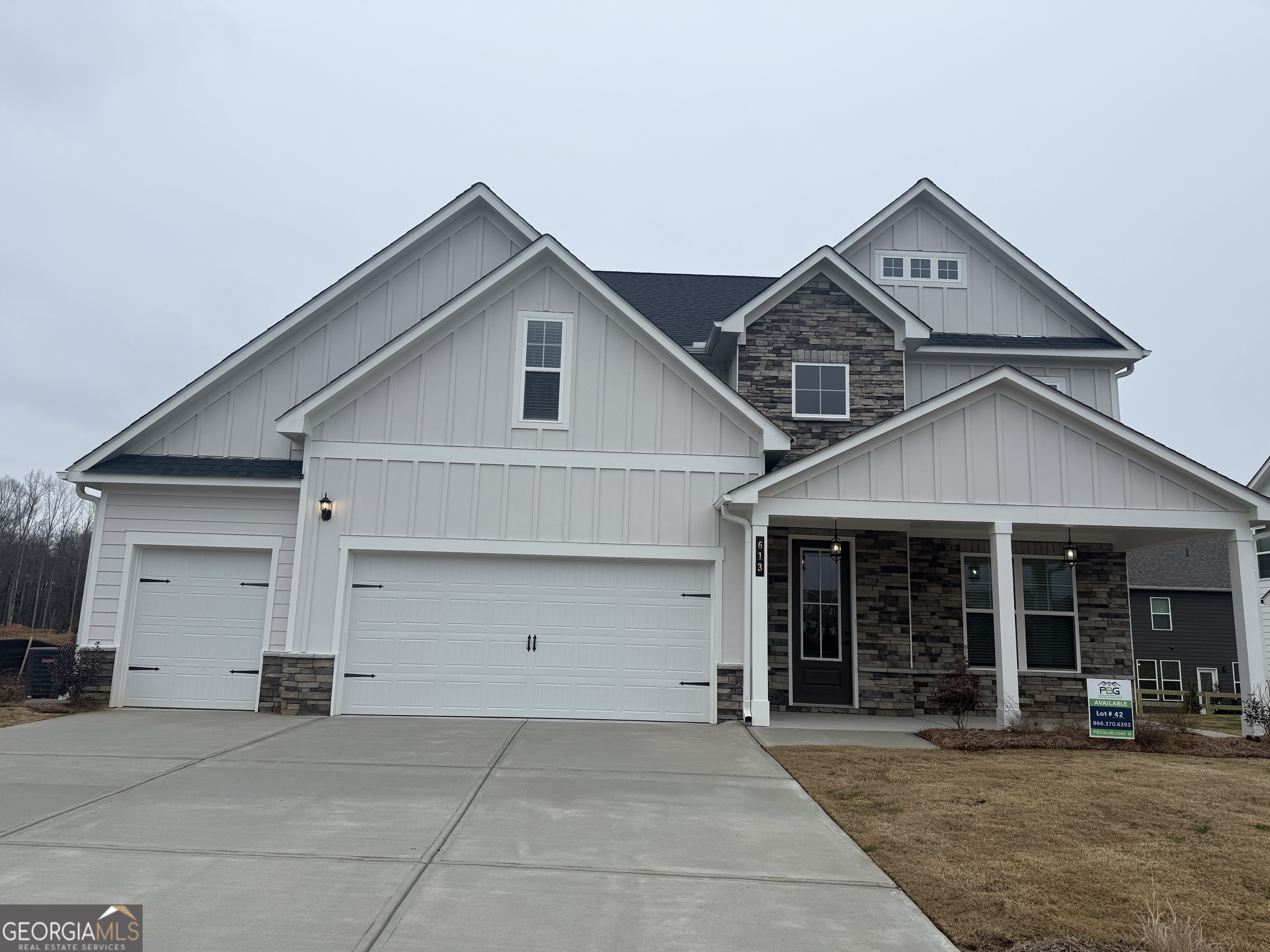 a view of a house with a yard and garage