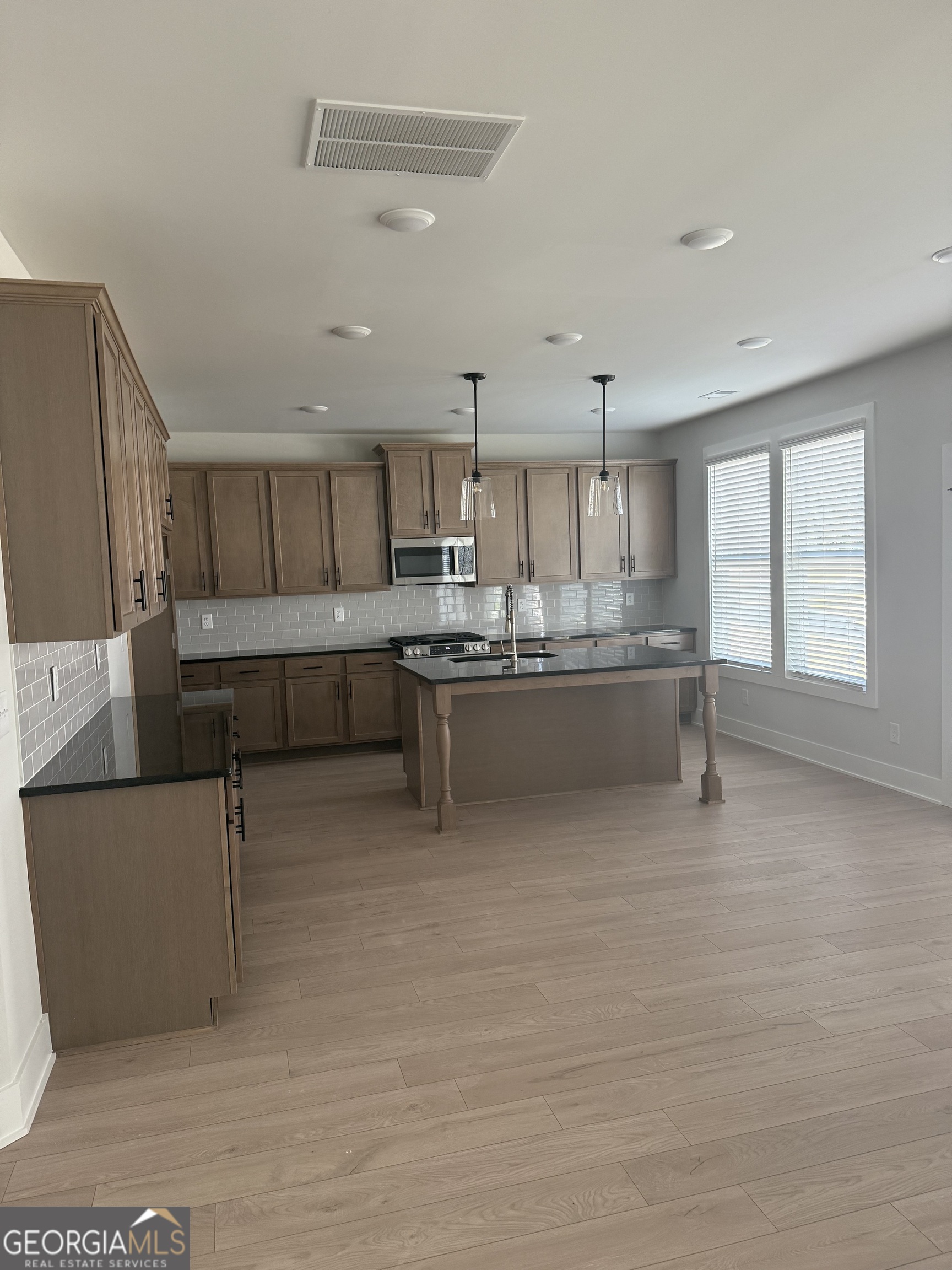 613 Villa Rica Springs Villa Rica, GA 30180 - Photo 11 of 14 a living room with stainless steel appliances kitchen island granite countertop furniture and a kitchen view