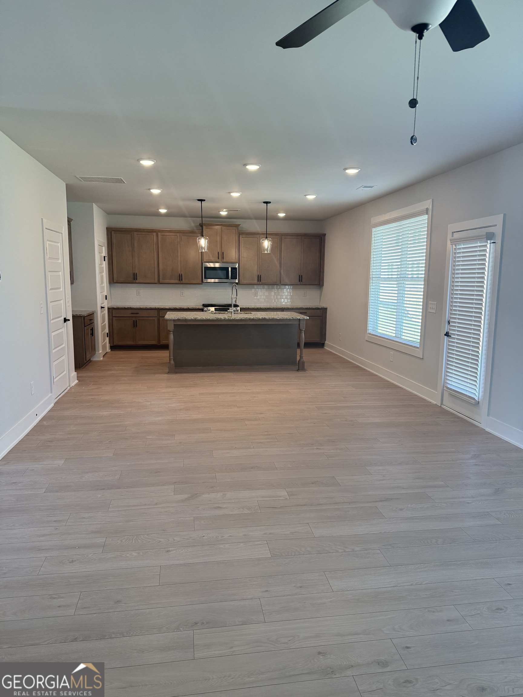 613 Villa Rica Springs Villa Rica, GA 30180 - Photo 13 of 14 a open kitchen with kitchen island a sink dishwasher a stove and a refrigerator with wooden floor
