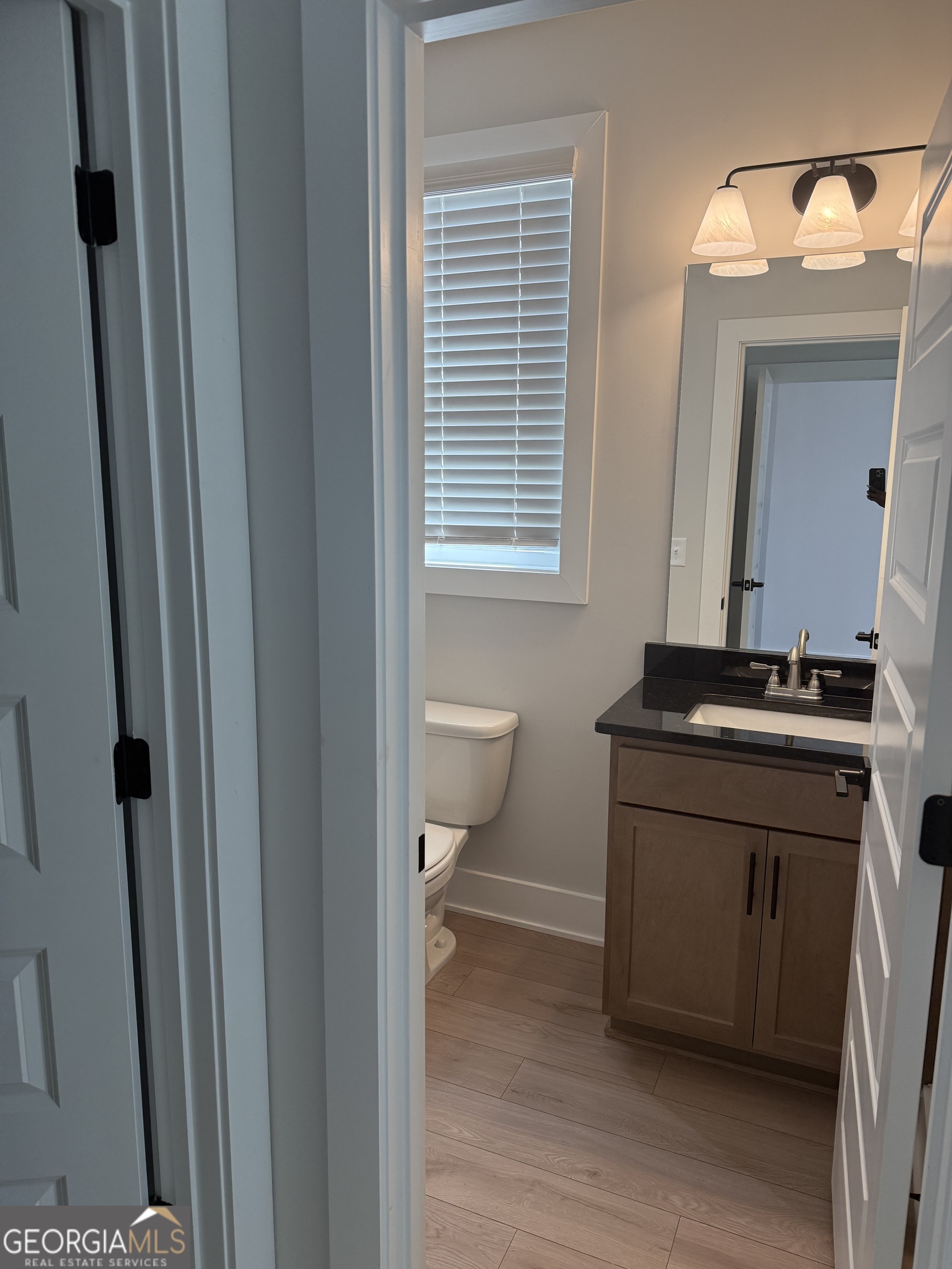 613 Villa Rica Springs Villa Rica, GA 30180 - Photo 10 of 14 a bathroom with a sink a toilet and a mirror