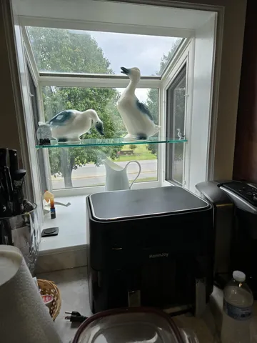 a room with a table chairs and window