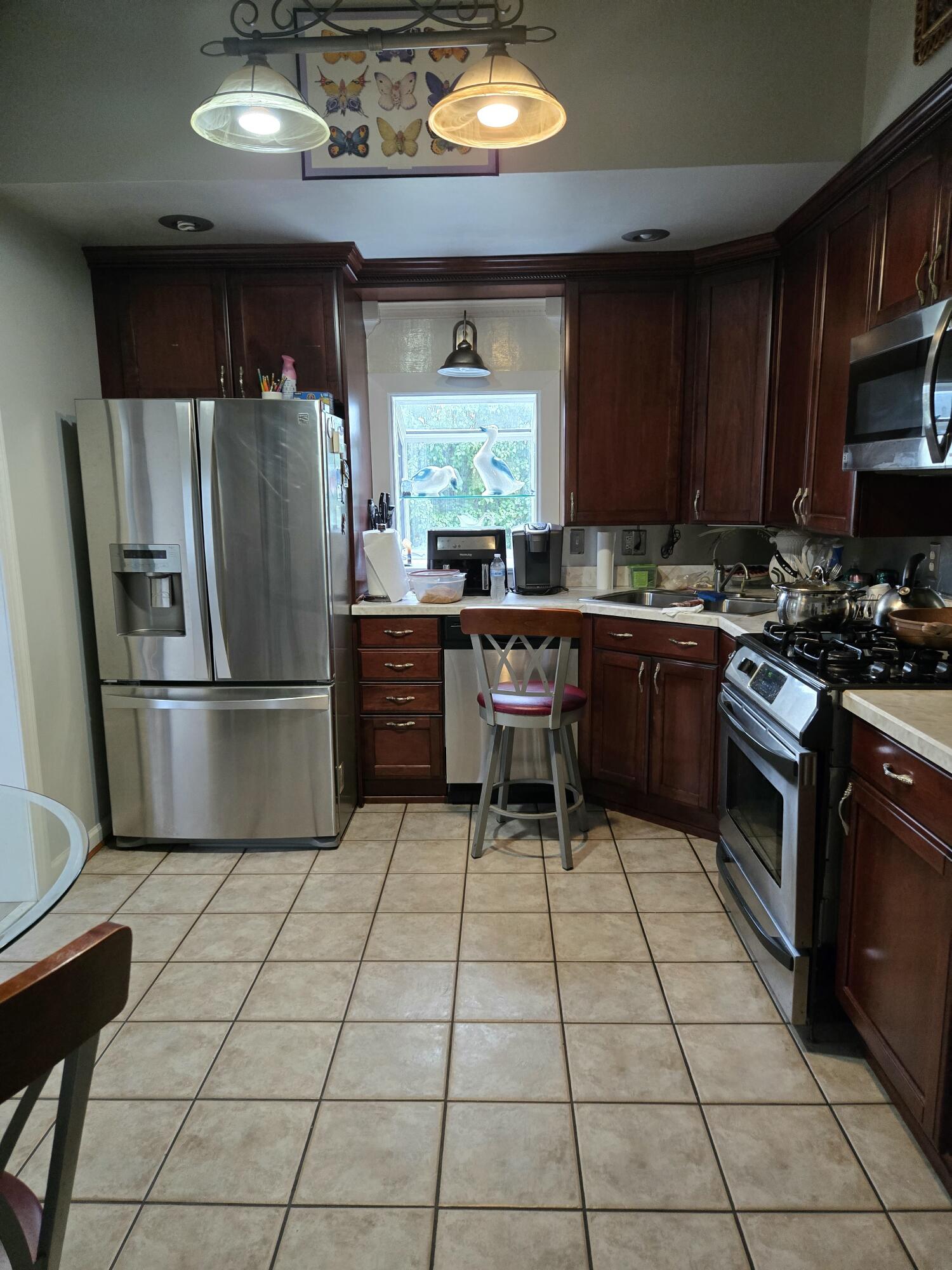8146 Williamson Road Roanoke, VA 24019 - Photo 3 of 27 a kitchen with stainless steel appliances granite countertop a stove refrigerator sink and cabinets