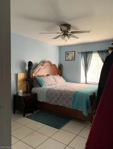 a bedroom with a bed and a mirror