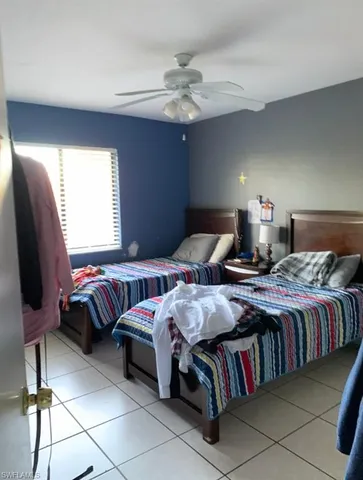 a bedroom with bed and a chandelier