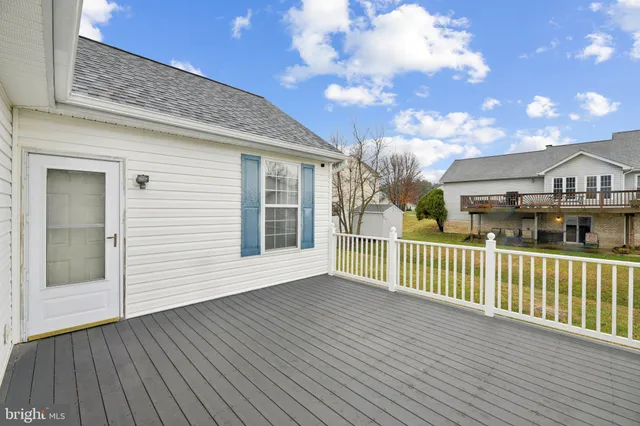 a view of a house with wooden deck
