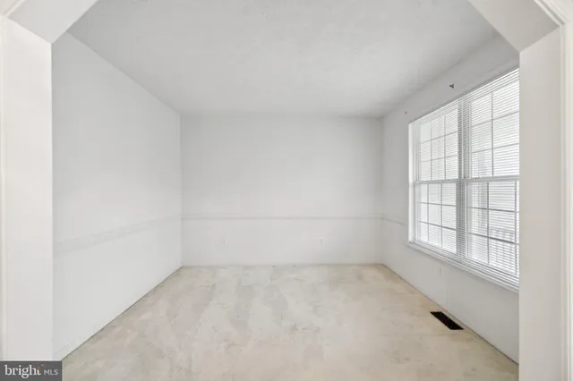 an empty room with a empty space and windows