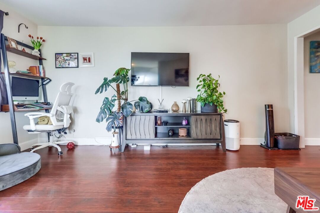 3734 South Canfield Avenue, Unit 331 Los Angeles, CA 90034 - Photo 15 of 45 a living room with furniture and a wooden floor