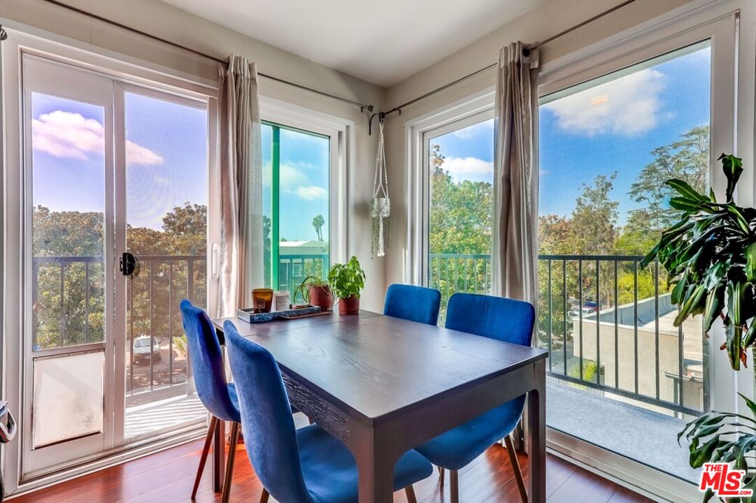 3734 South Canfield Avenue, Unit 331 Los Angeles, CA 90034 - Photo 16 of 45 a view of a dining room with furniture window and wooden floor