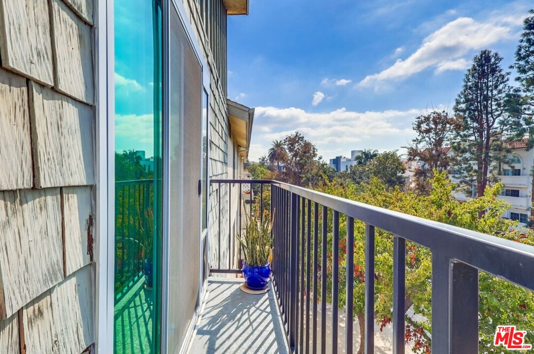 3734 South Canfield Avenue, Unit 331 Los Angeles, CA 90034 - Photo 27 of 45 a view of a balcony with wooden floor & fence