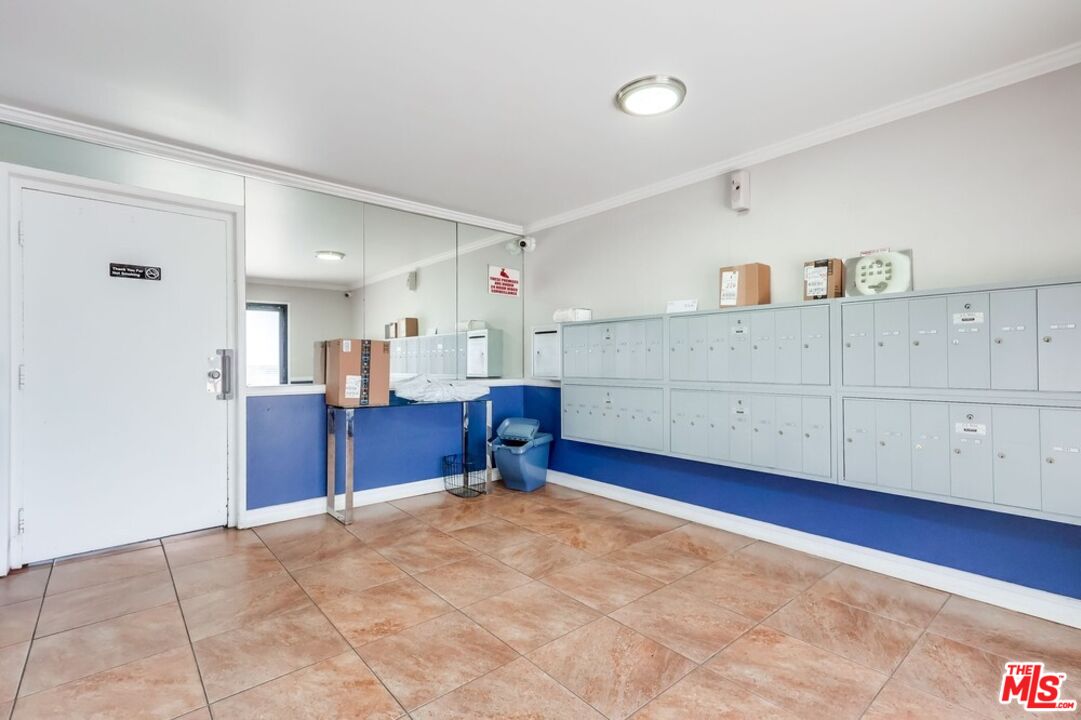 3734 South Canfield Avenue, Unit 331 Los Angeles, CA 90034 - Photo 40 of 45 a bedroom with furniture and mirror