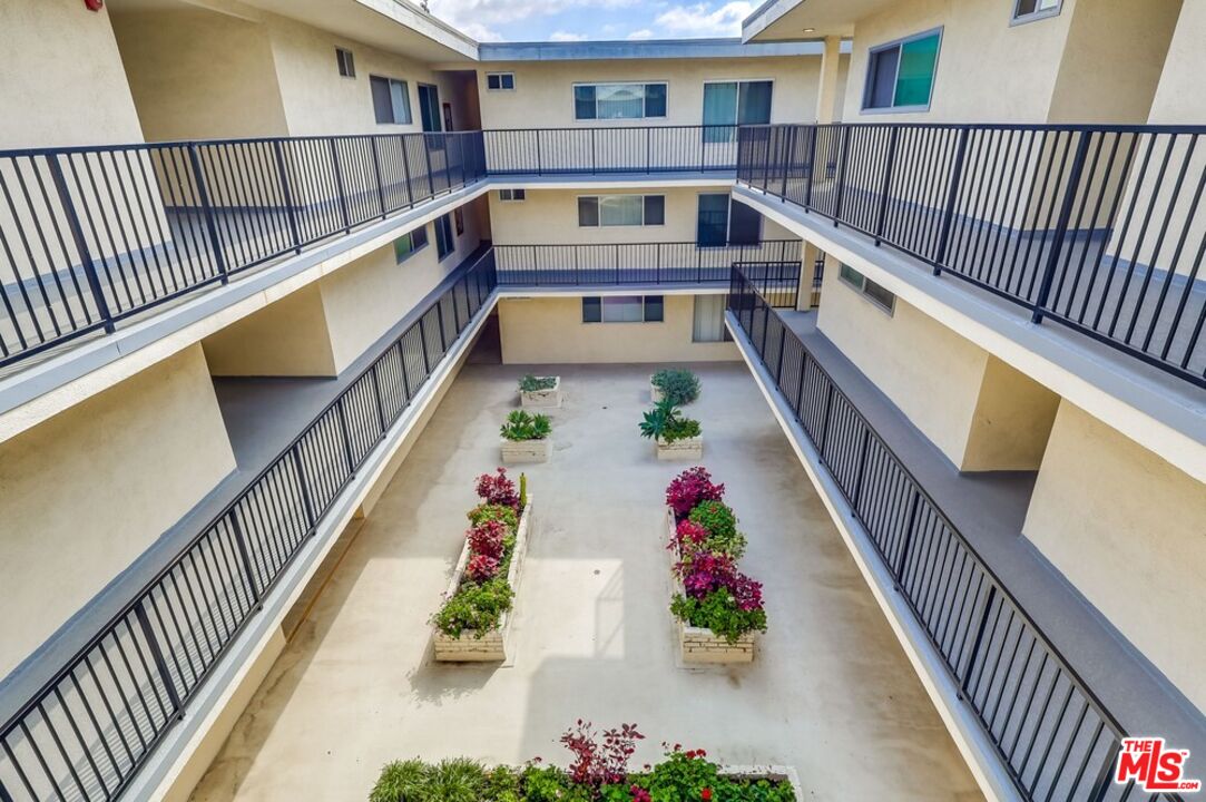 3734 South Canfield Avenue, Unit 331 Los Angeles, CA 90034 - Photo 8 of 45 a view of balcony with wooden floor and potted plants