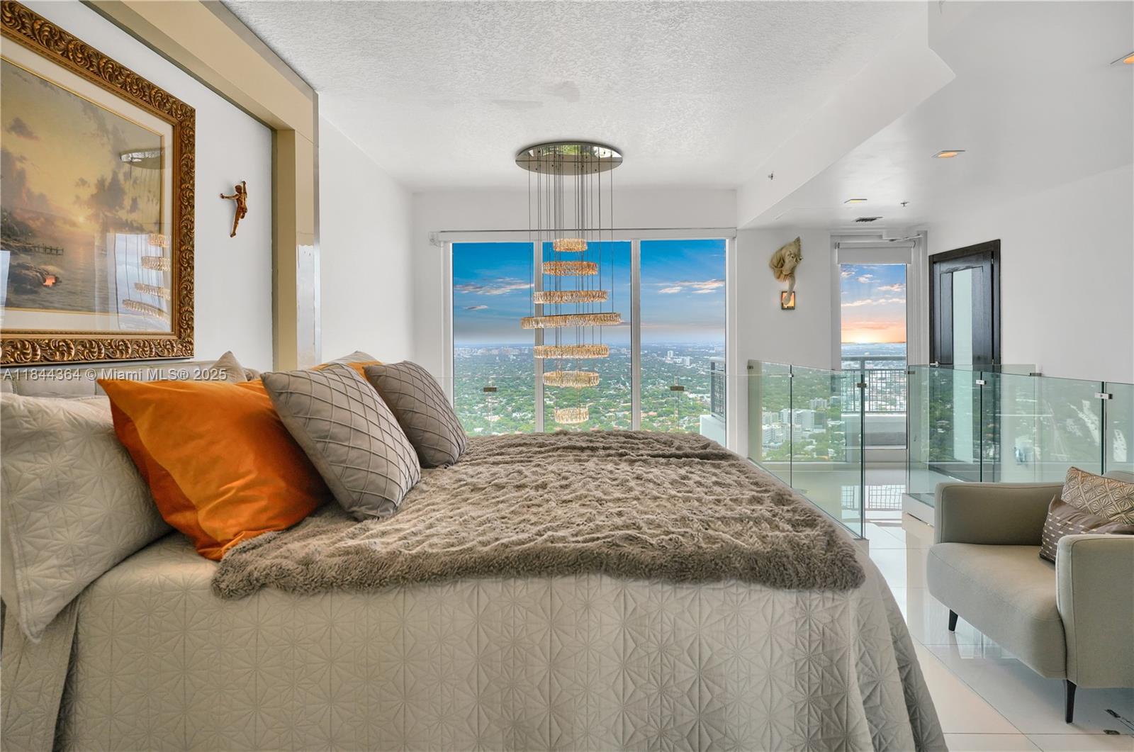 60 Southwest 13th Street, Unit 4411 Miami, FL 33130 - Photo 12 of 38 a bedroom with a large bed and a balcony