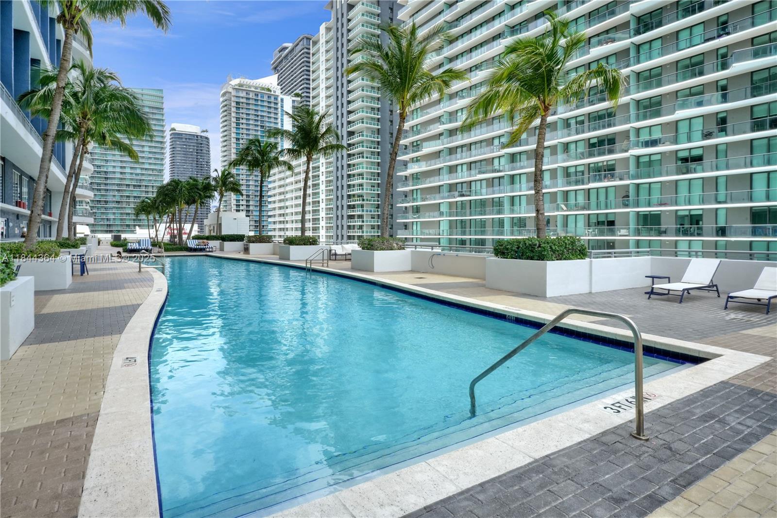 60 Southwest 13th Street, Unit 4411 Miami, FL 33130 - Photo 20 of 38 a view of a swimming pool with a patio