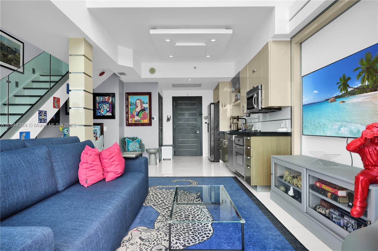 60 Southwest 13th Street, Unit 4411 Miami, FL 33130 - Photo 3 of 38 a living room with furniture and flat screen tv