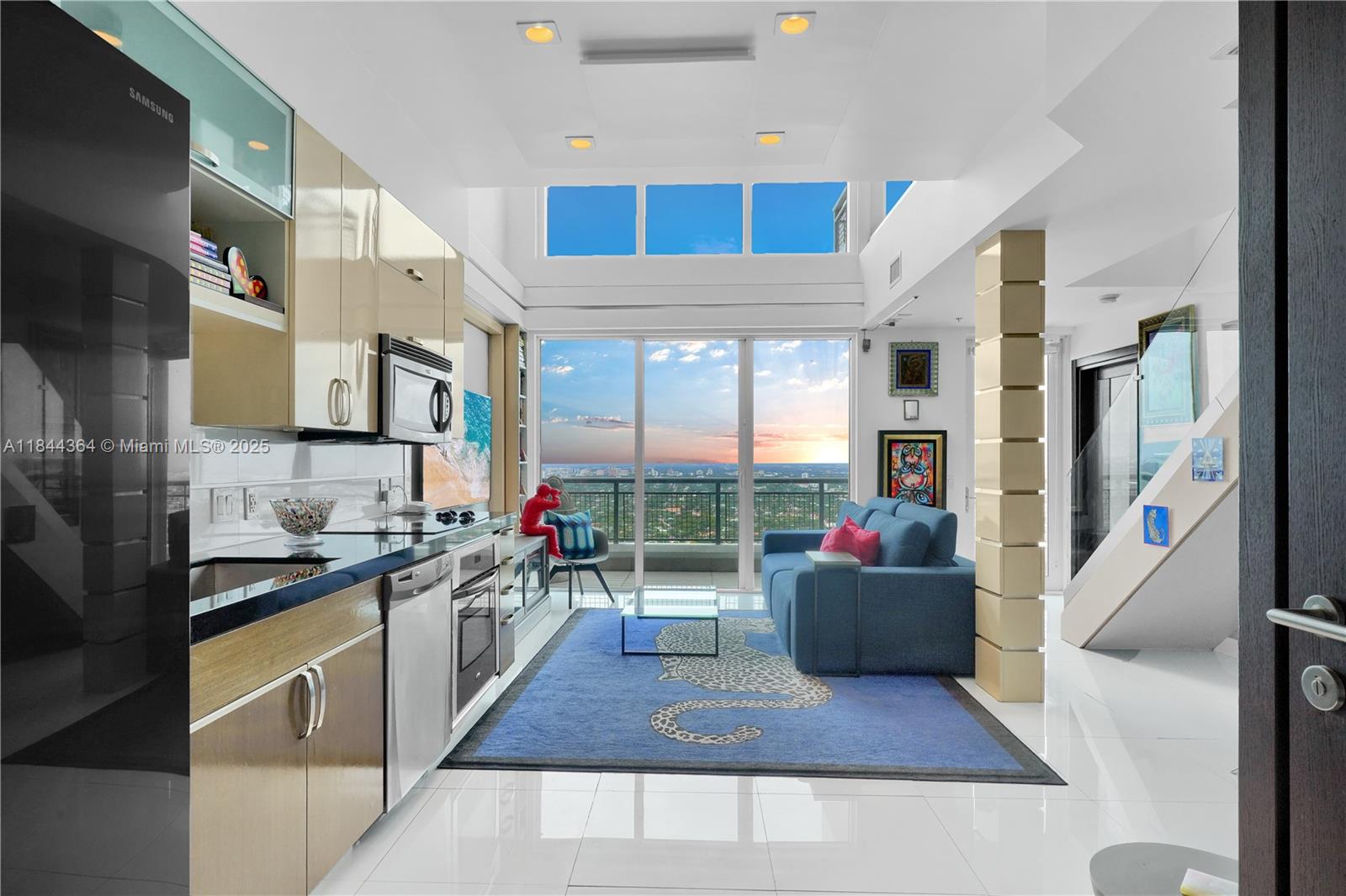 60 Southwest 13th Street, Unit 4411 Miami, FL 33130 - Photo 36 of 38 a living room with stainless steel appliances furniture a rug and a kitchen view