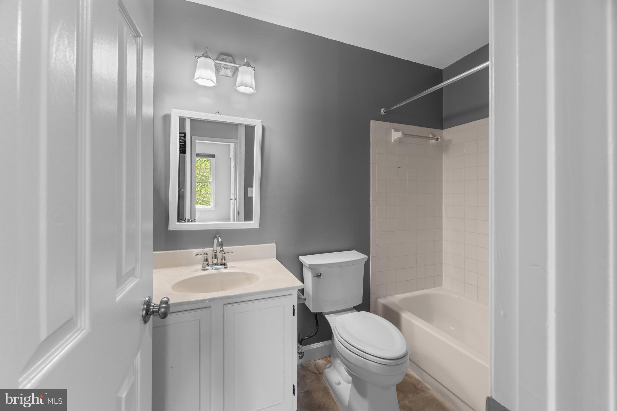 9302 Player Drive, Unit 155 Laurel, MD 20708 - Photo 36 of 43 a white toilet sitting next to a bathroom sink