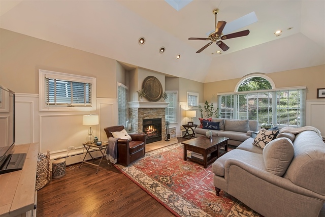 72 Abbotsford Road Winnetka, IL 60093 - Photo 9 of 29 a living room with furniture a fireplace and a flat screen tv