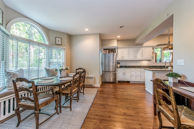 72 Abbotsford Road Winnetka, IL 60093 - Photo 10 of 29 a kitchen with stainless steel appliances kitchen island granite countertop a table chairs sink and cabinets