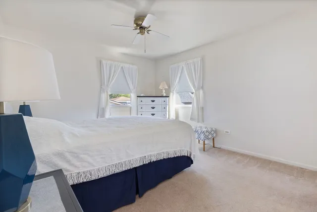 a spacious bedroom with a bed and a chandelier