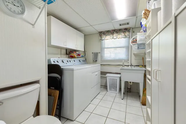 a utility room with cabinets dryer and washer
