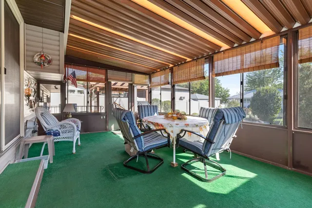 a view of a backyard with table and chairs