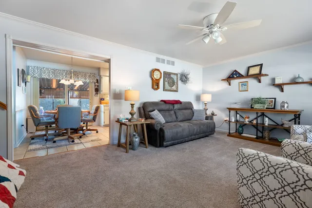 a living room with furniture and a gym machine