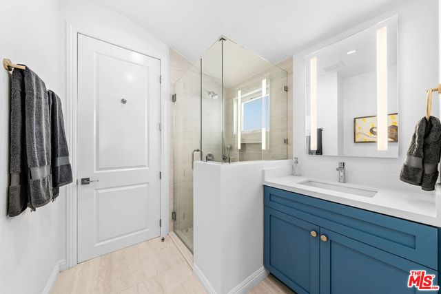 a bathroom with a double vanity sink a and a mirror