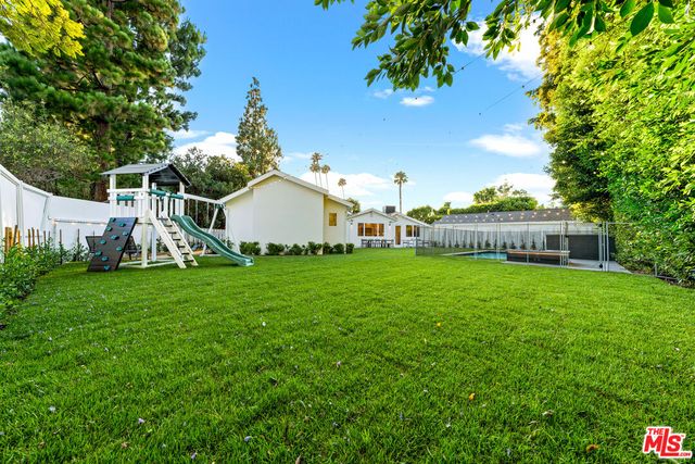 a view of a patio with a table and chairs