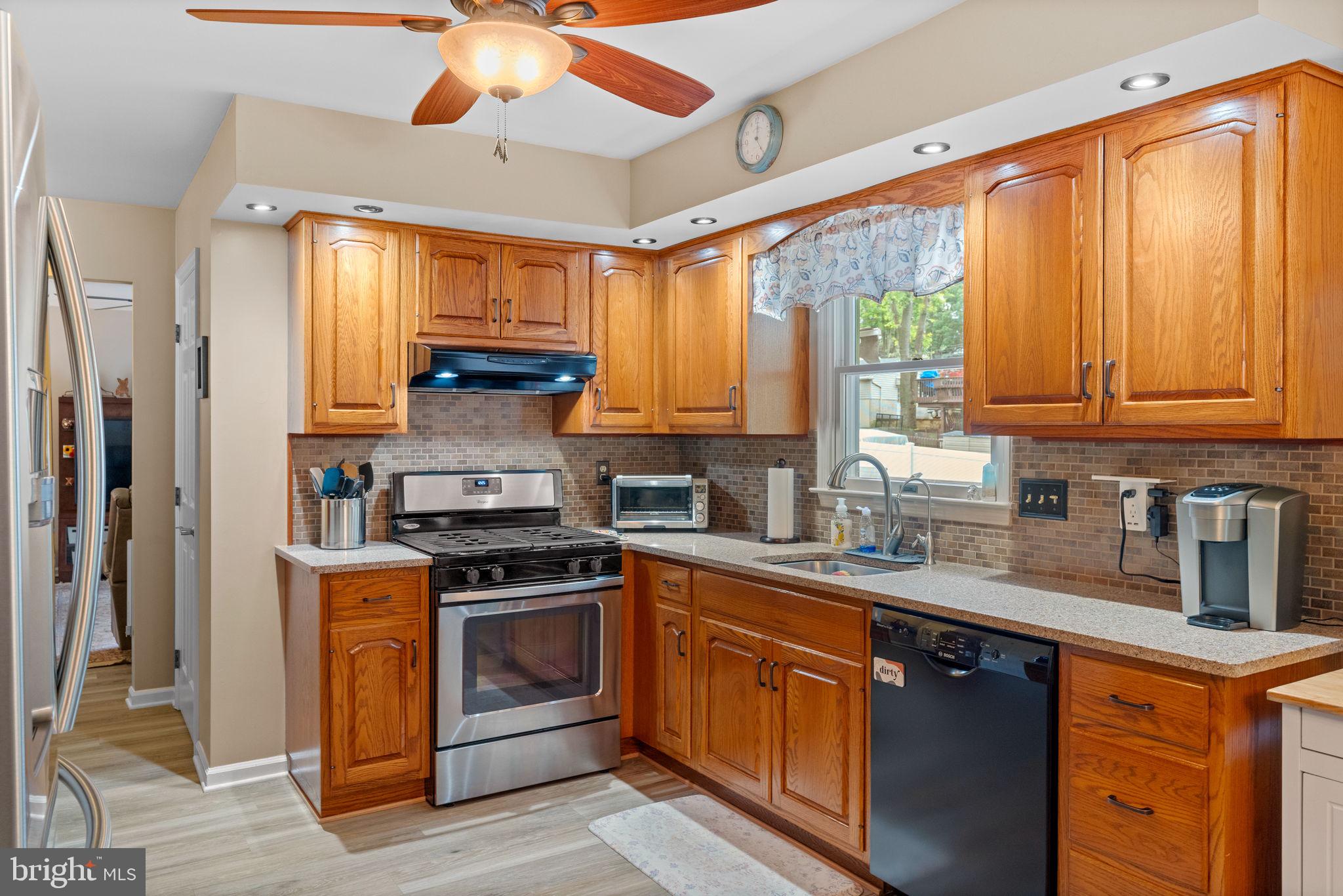 1036 Boeshore Circle Reading, PA 19605 - Photo 15 of 52 a kitchen with stainless steel appliances granite countertop a stove a sink and a microwave