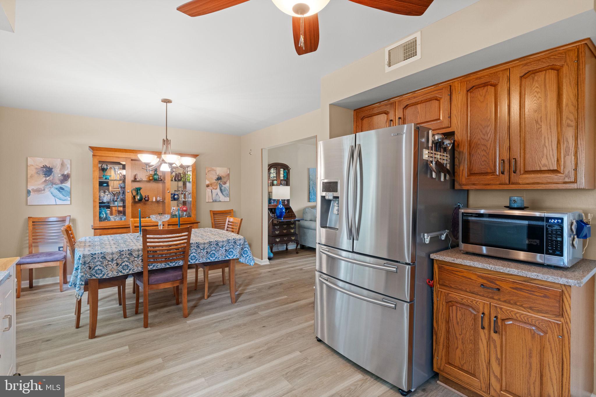 1036 Boeshore Circle Reading, PA 19605 - Photo 17 of 52 a kitchen with stainless steel appliances granite countertop a refrigerator microwave and wooden floor