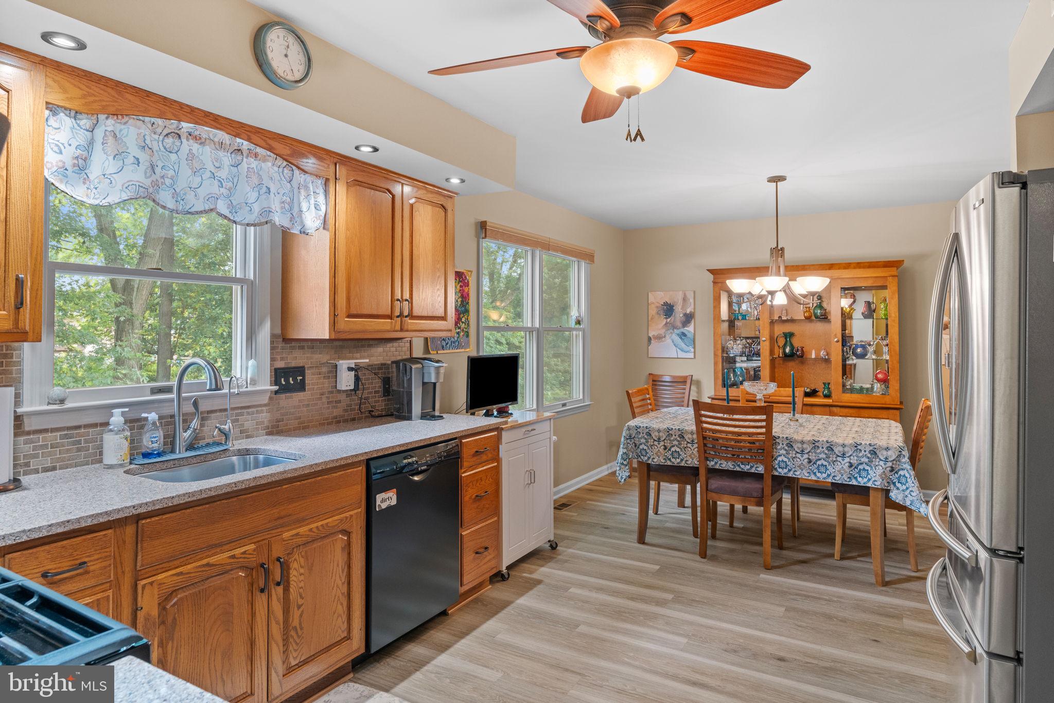 1036 Boeshore Circle Reading, PA 19605 - Photo 19 of 52 a kitchen with stainless steel appliances granite countertop wooden cabinets a dining table and chairs