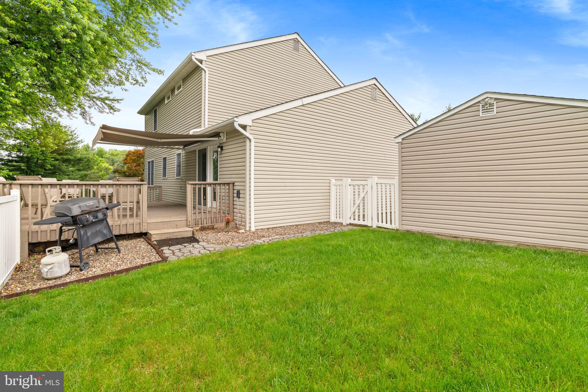 1036 Boeshore Circle Reading, PA 19605 - Photo 47 of 52 a view of a white house with a yard and table and chairs