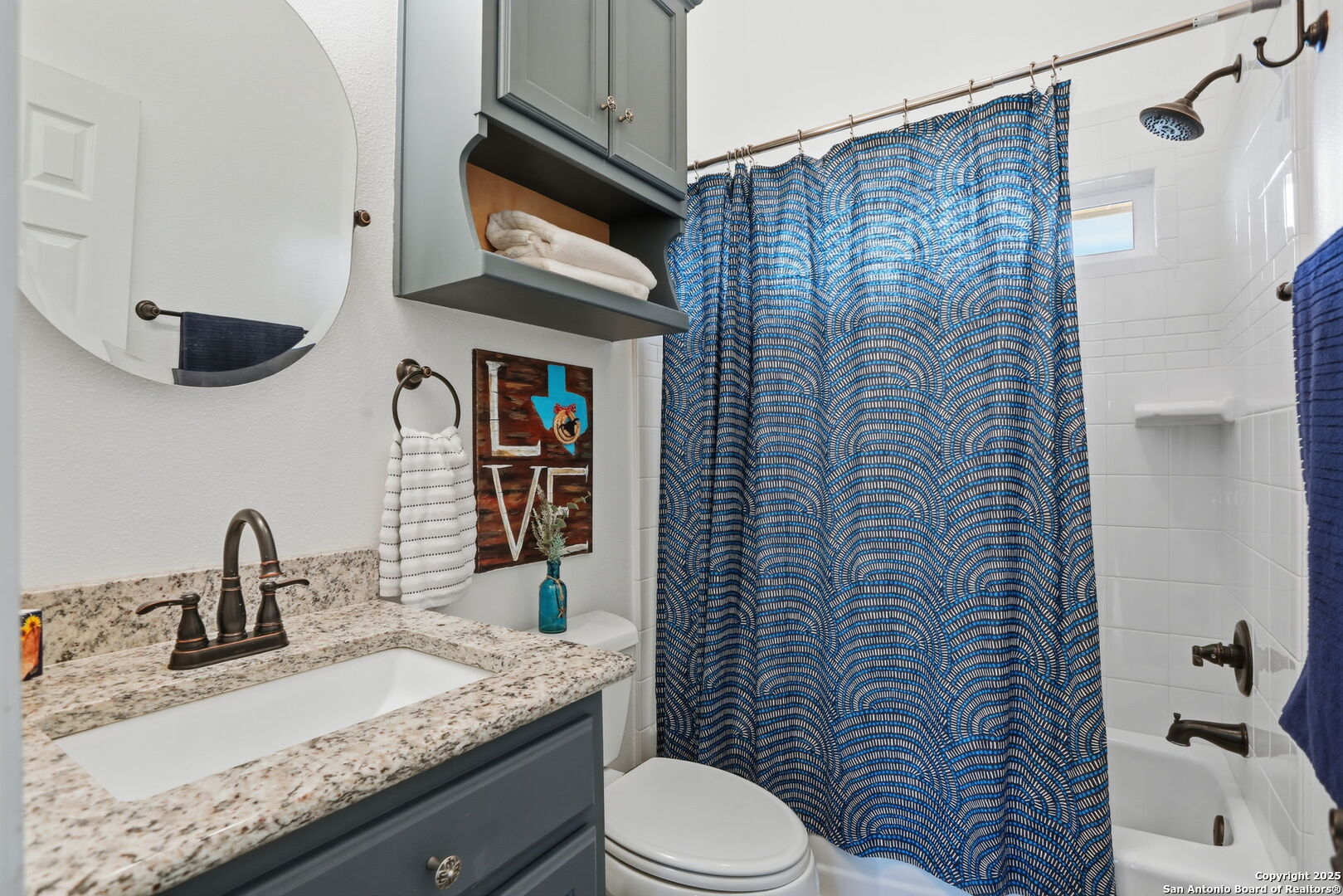 116 Martingale Trail Bandera, TX 78003 - Photo 13 of 40 a bathroom with a granite countertop sink mirror vanity and toilet