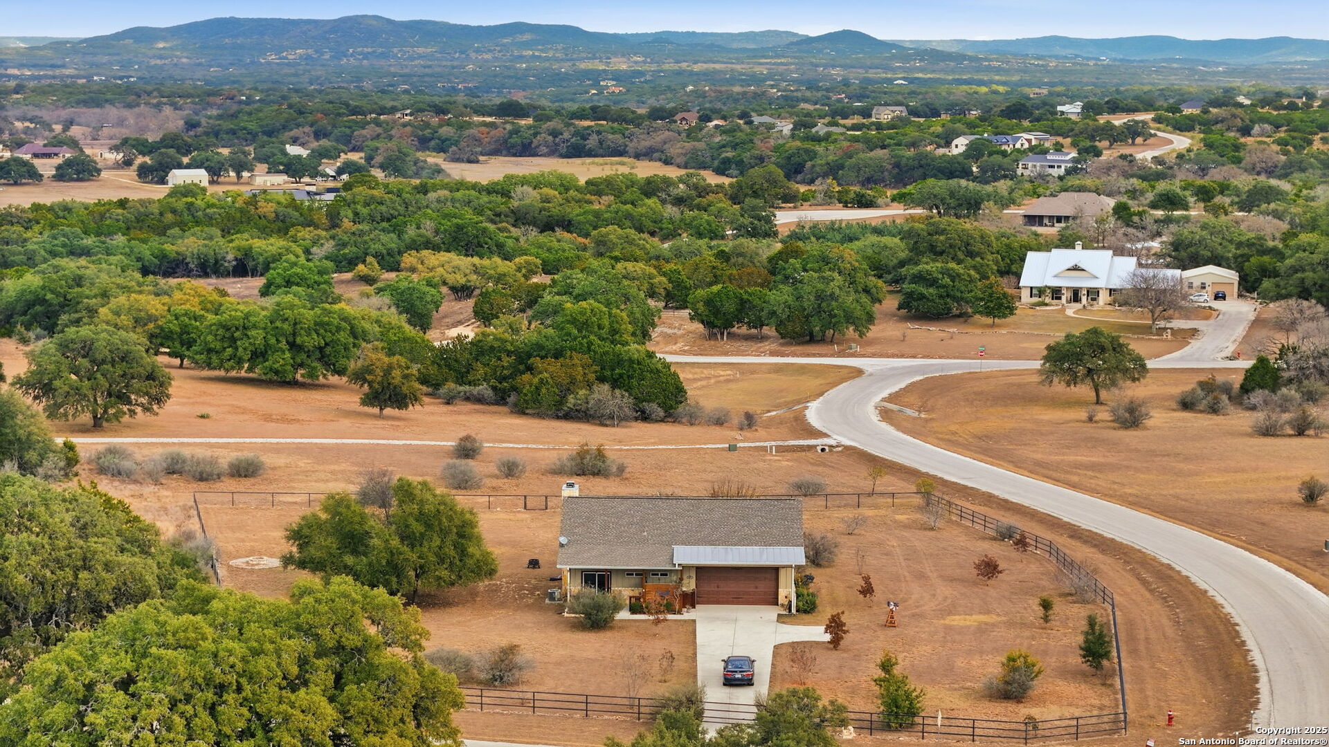 116 Martingale Trail Bandera, TX 78003 - Photo 4 of 40 an aerial view of residential houses with outdoor space and parking