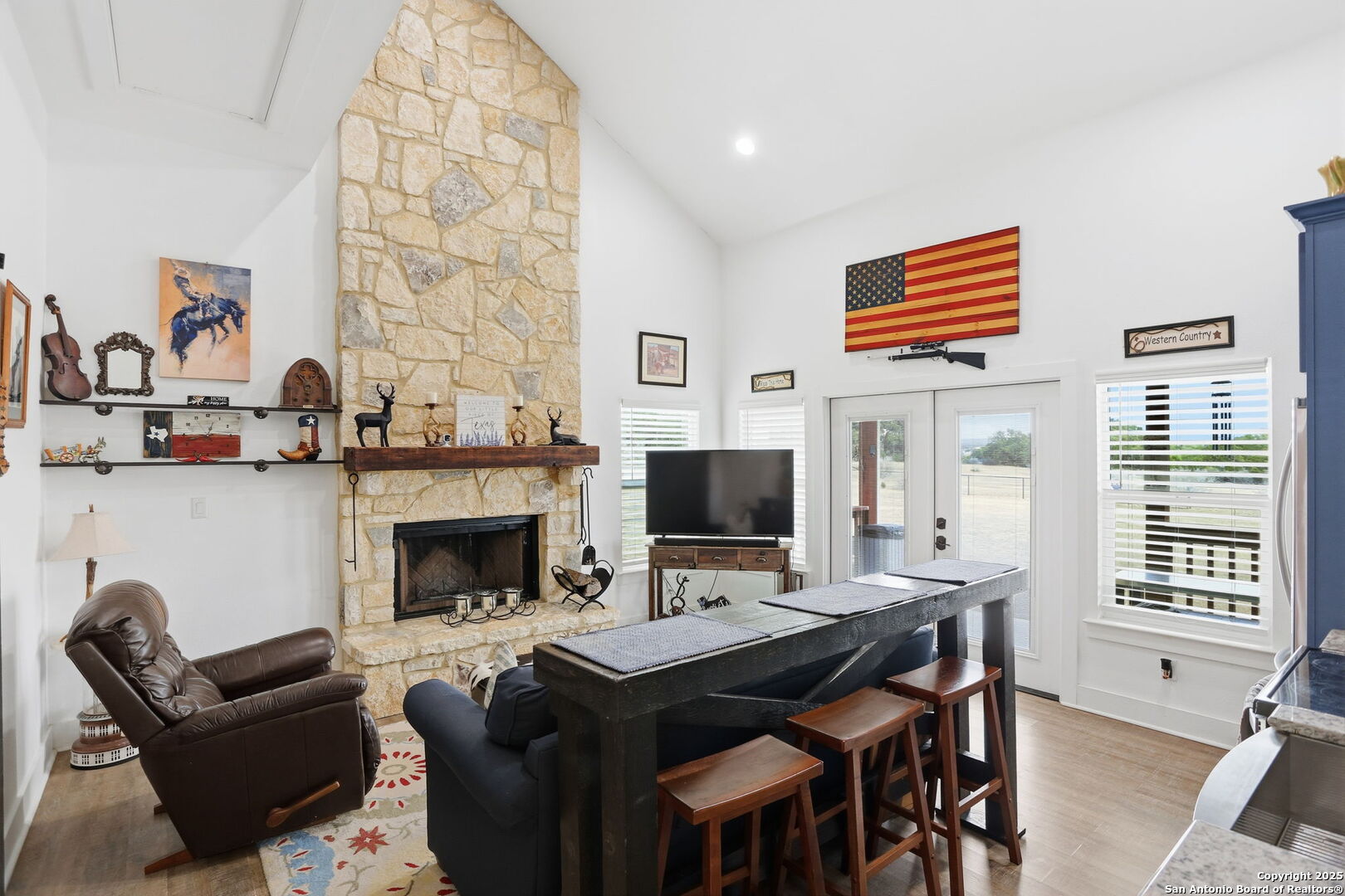116 Martingale Trail Bandera, TX 78003 - Photo 5 of 40 a living room with furniture a fireplace and a flat screen tv