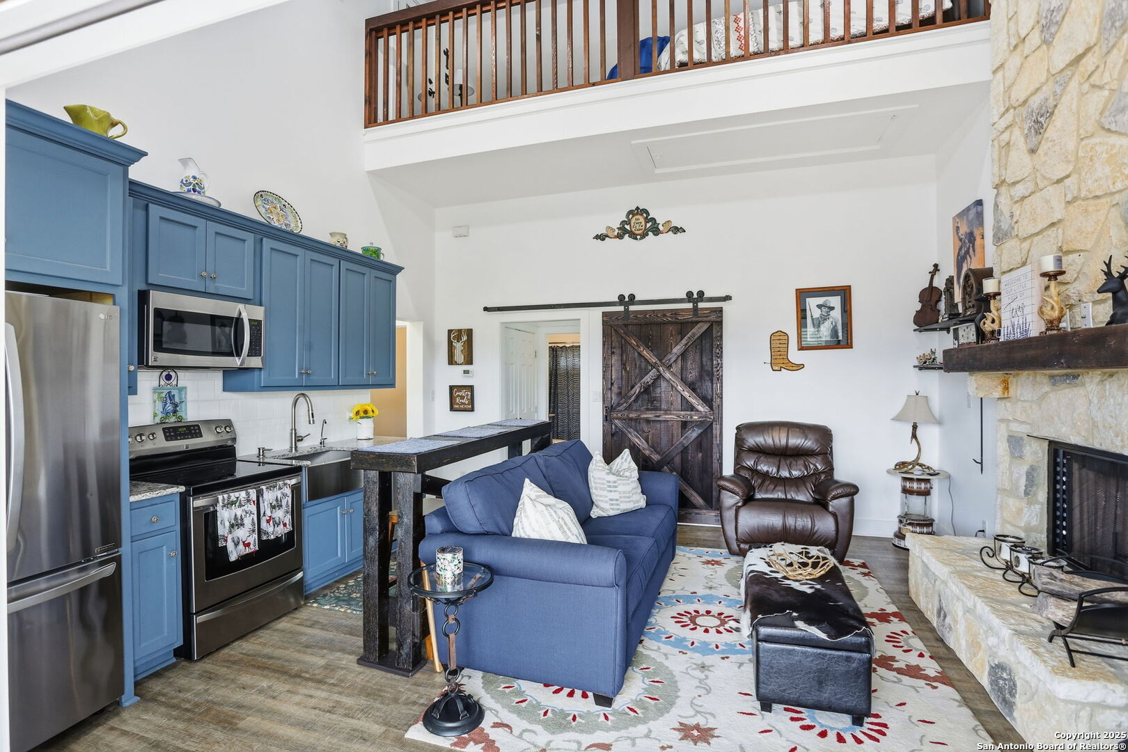 116 Martingale Trail Bandera, TX 78003 - Photo 7 of 40 a living room with furniture a fireplace and a flat screen tv