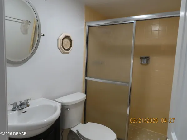 a bathroom with a sink toilet and a mirror