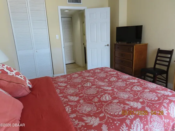 a bedroom with a bed and a television