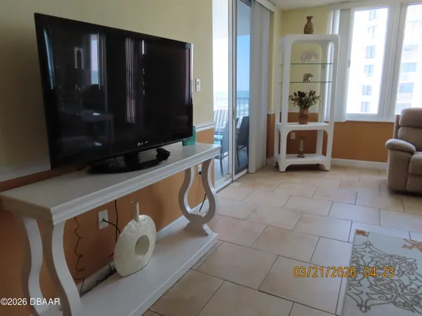 a view of living room with furniture and a flat screen tv