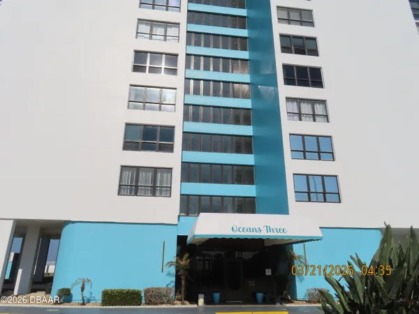 a view of a building with potted plants