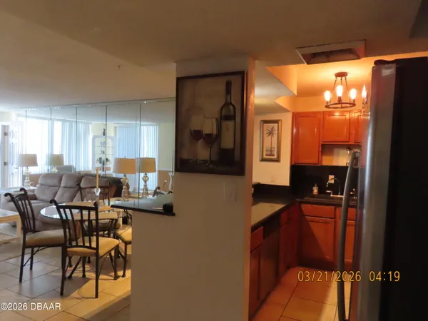 a kitchen with stainless steel appliances kitchen island granite countertop a refrigerator and a stove