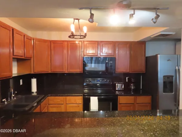 a living room with furniture a flat screen tv and a floor to ceiling window